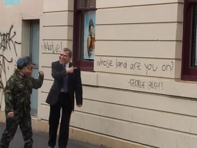 Saddama Bin Laden and George Dubya Pussy from N.H.I.V. with some inner suburban graffiti reading "whose land are you on?" followed by "George Bush's".